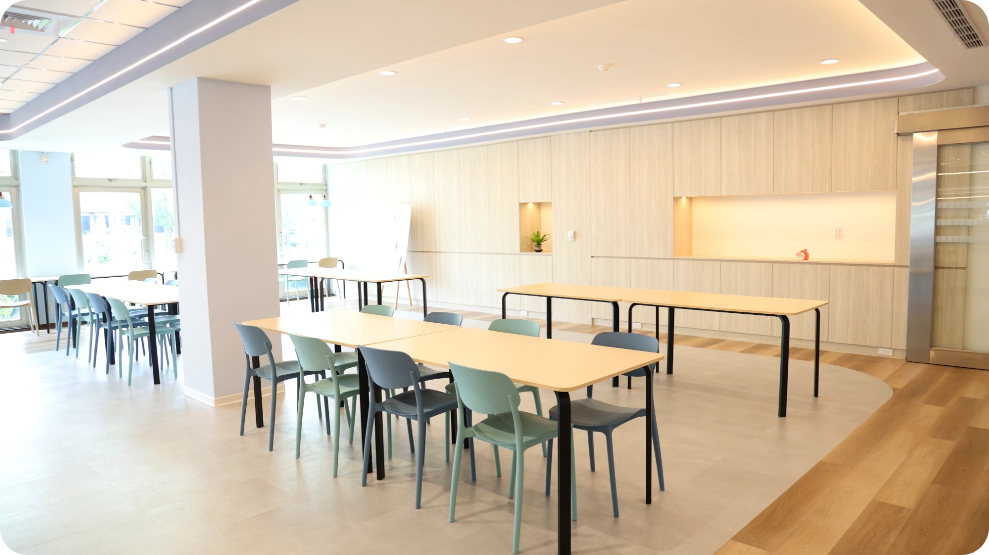 Dining area with curved ceiling detail and dark timber-grain flooring